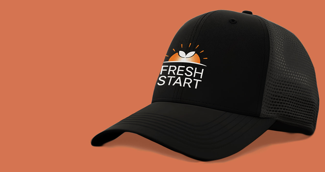 Black cap with 'Fresh Start' logo on an orange background